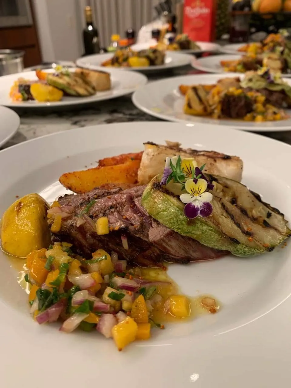 Grilled steak with mango salsa and roasted vegetables